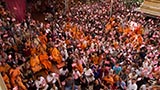 Sadhus and devotees wave flags commemorating 60 years of BAPS Youth Activities