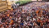 Sadhus and devotees wave flags commemorating 60 years of BAPS Youth Activities