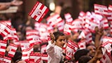 Devotees wave flags commemorating 60 years of BAPS Youth Activities