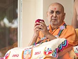  Swamishri sanctifies a ball of flowers