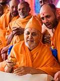 Swamishri sanctifies the decorated coconut 