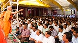  Pujya Mahant Swami blesses devotees by showering rice grains