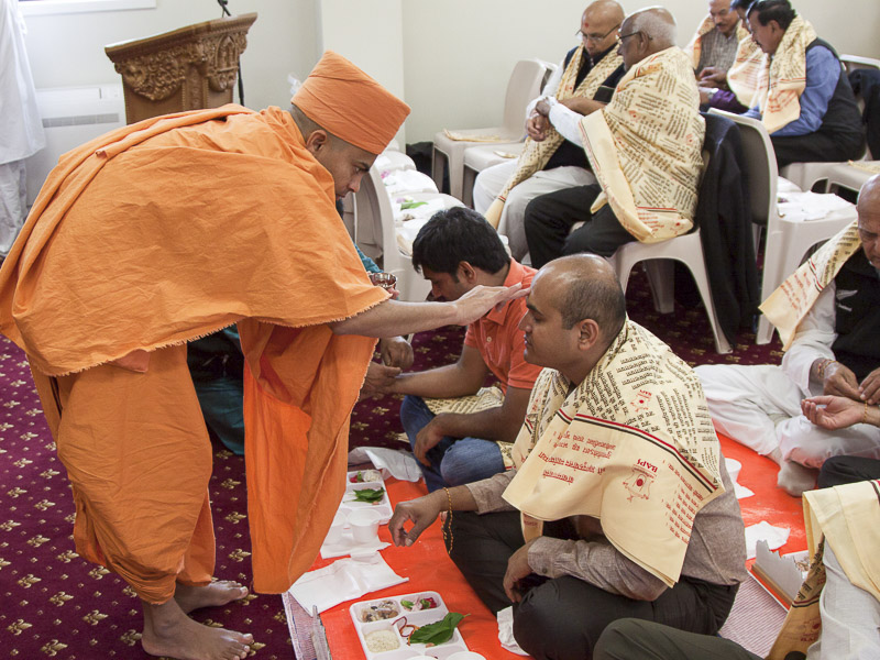 Devotees participate in murti-pratishtha mahapuja