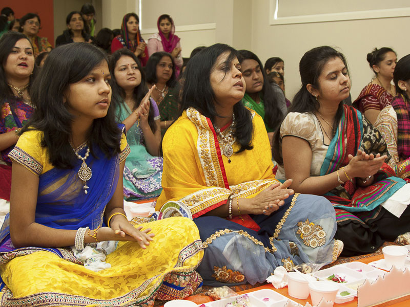 Devotees participate in murti-pratishtha mahapuja