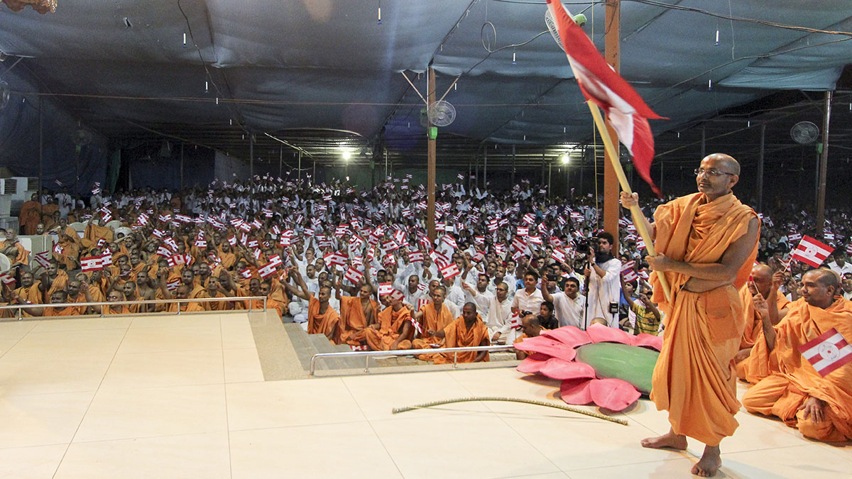 Sadhus and devotees wave BAPS flags