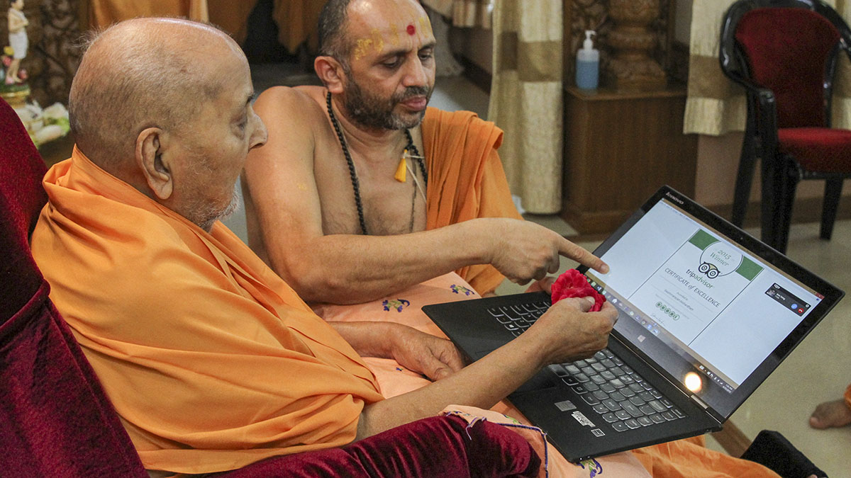 Swamishri observes a TripAdvisor Certificate of Excellence awarded to Swaminarayan Akshardham, Gandhinagar