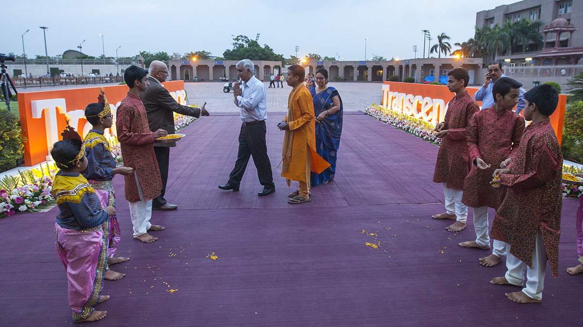 Children welcome guests with flower petals