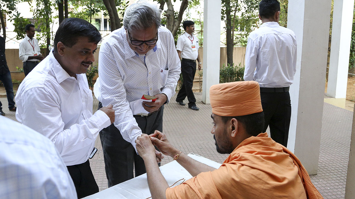 Guest are welcomed by tying nadachhadi, a sacred thread