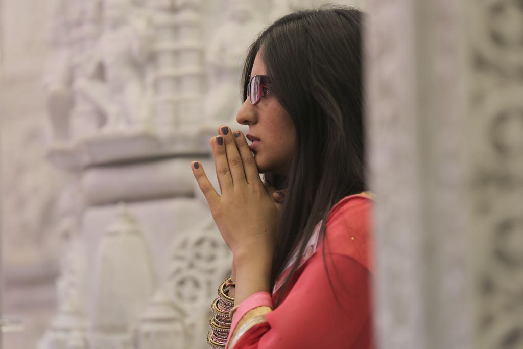 Visitors engrossed in darshan