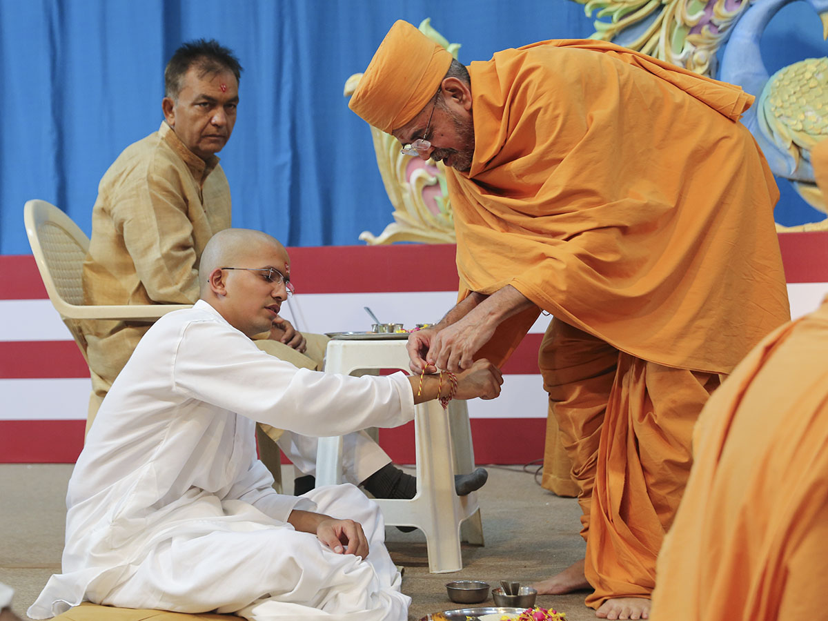 A sanctified nadachhadi is tied to each sadhak's wrist