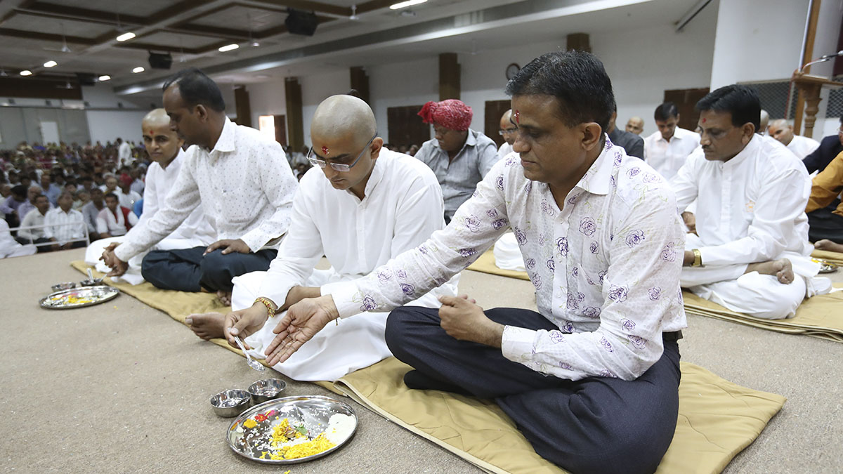 Sadhaks and their fathers engaged in mahapuja rituals