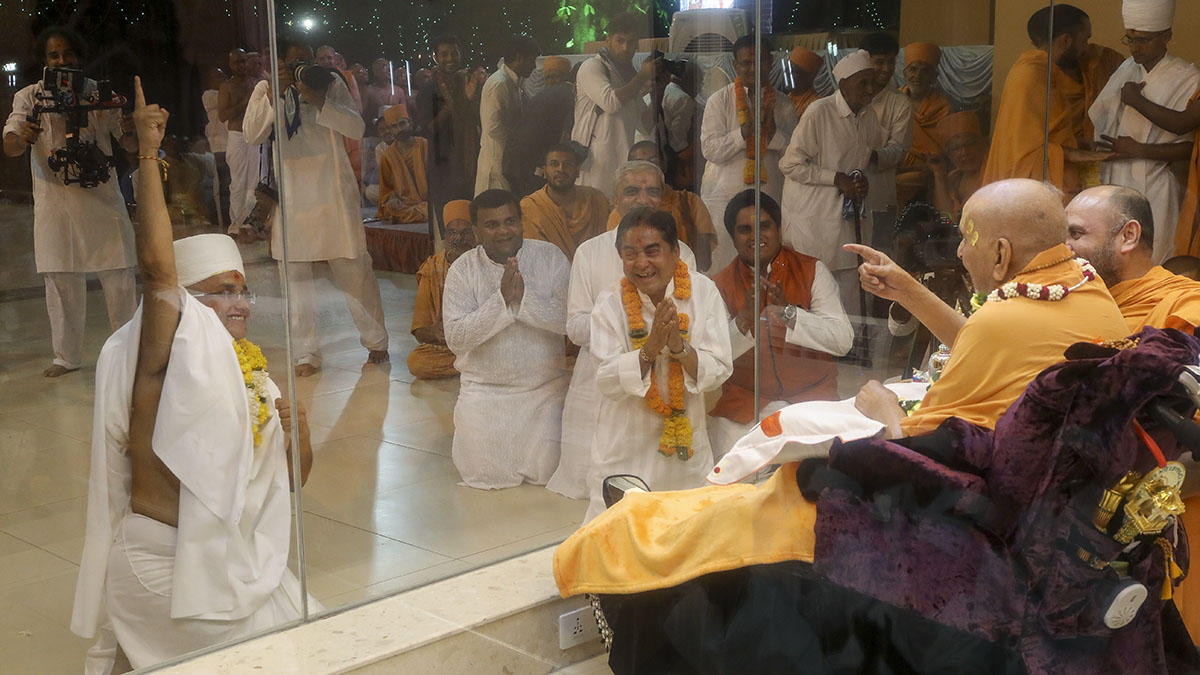 Swamishri with a newly initiated parshad and his father and relatives