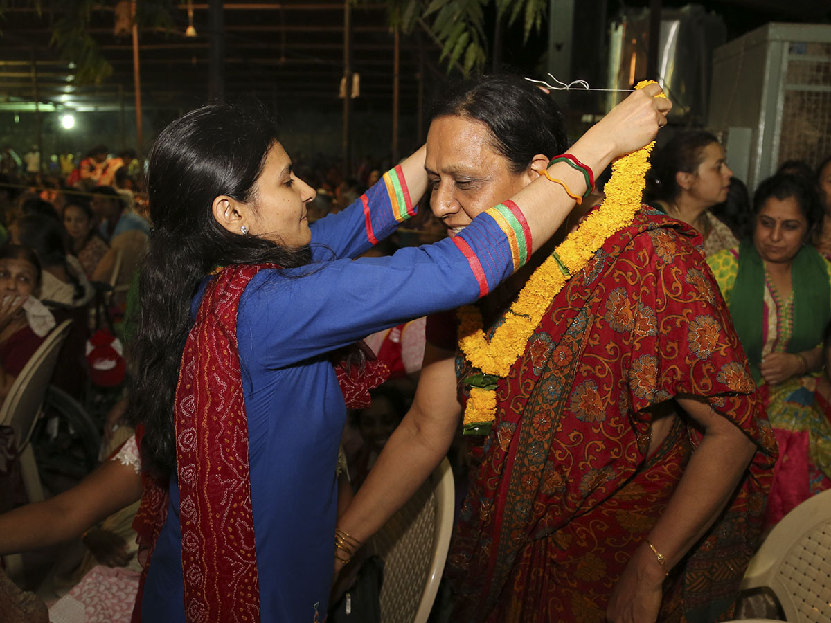 Mothers of the newly initiated sadhus are honored with garlands