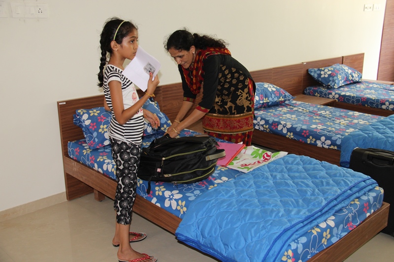 Mother helping the daughter in the hostel