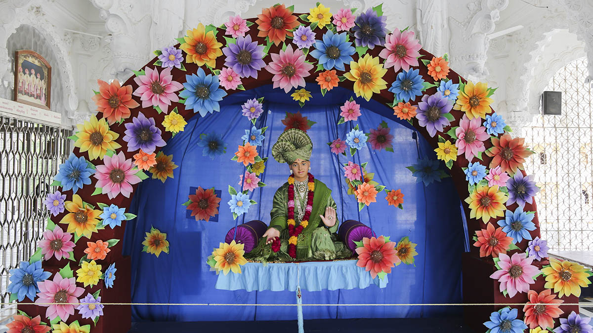 Bhagwan Swaminarayan (utsav murti) in a decorative hindolo
