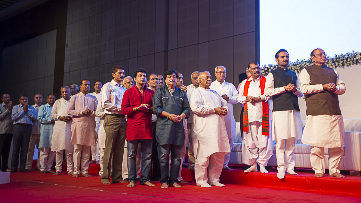 Stage guests and other dignitaries offer mantra pushpanjali
