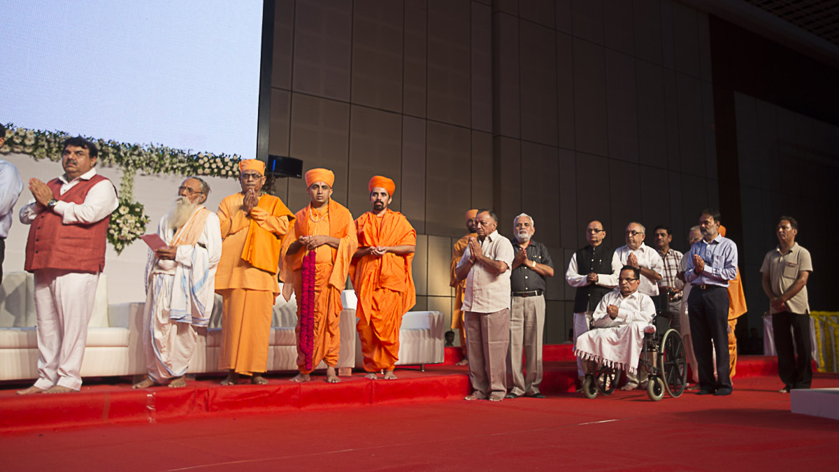 Stage guests and other dignitaries offer mantra pushpanjali