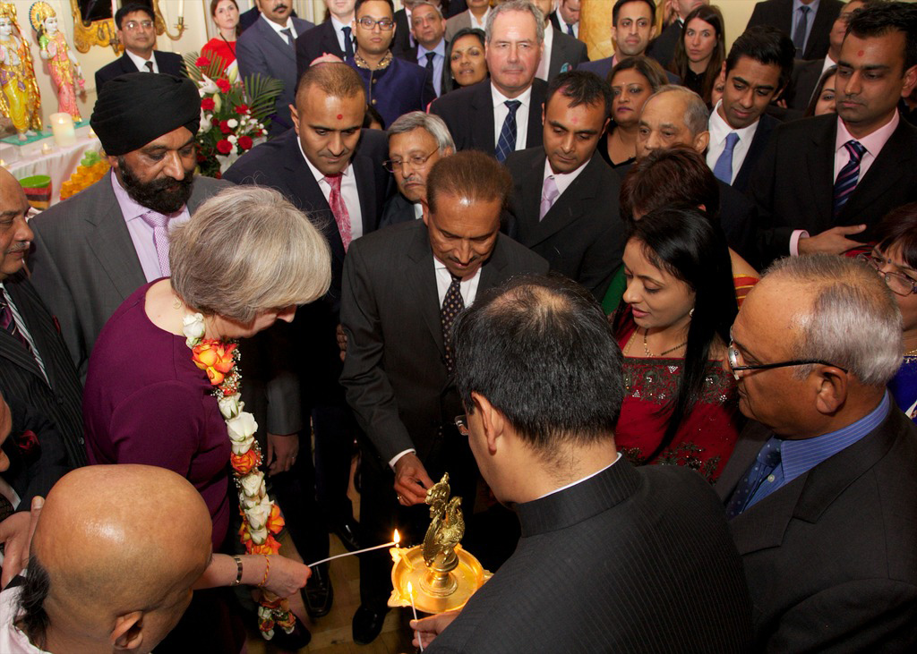 Prime Minister Theresa May, Acting Indian High Commissioner Dinesh Patnaik and BAPS Trustee Jitu Patel light divo at 10 Downing Street Diwali Reception