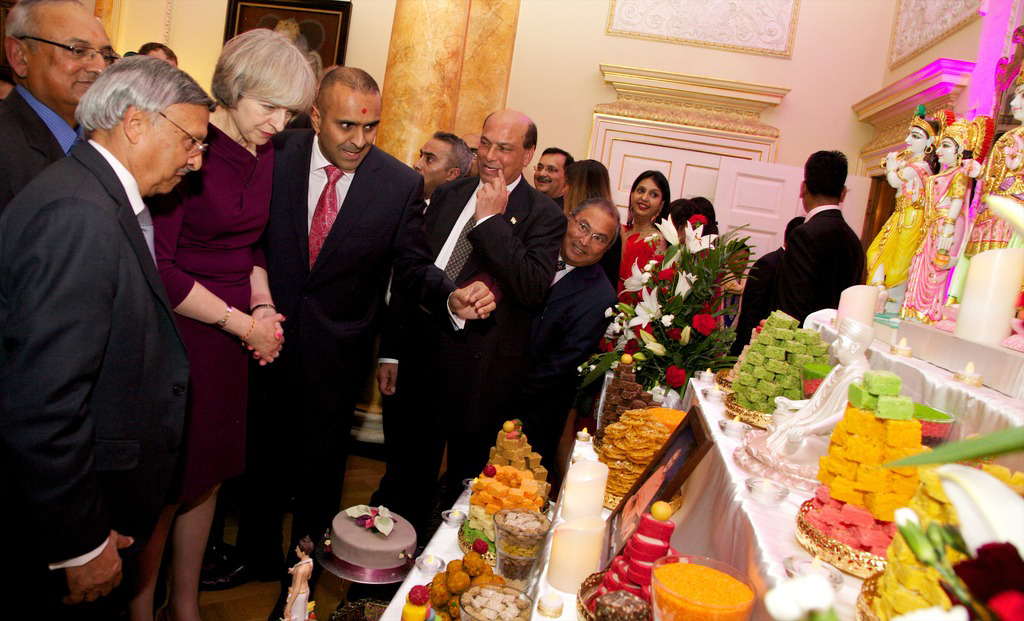 Prime Minister Theresa May observes the annakut offering at 10 Downing Street