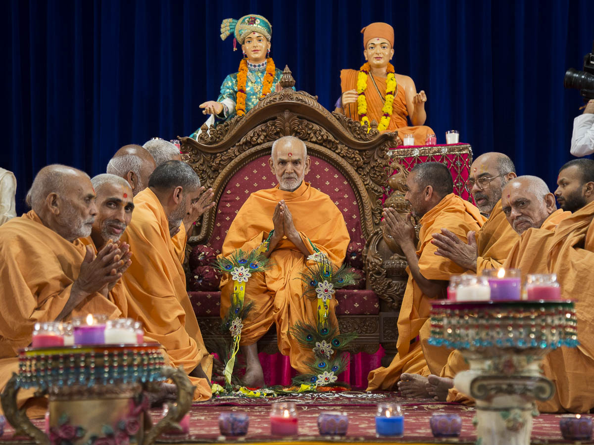 Sadhus honor Param Pujya Mahant Swami with a garland