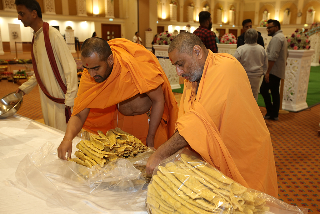 Volunteers and swamis preparing for Annakut, London, UK