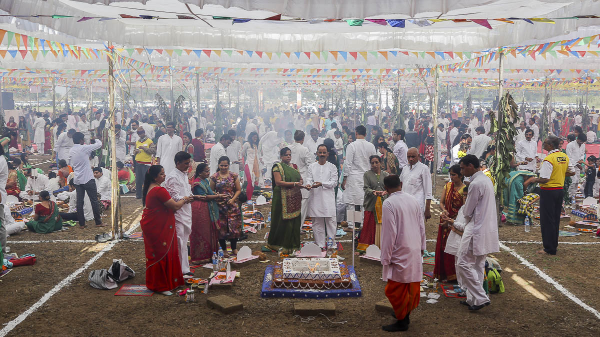 Devotees participate in yagna rituals