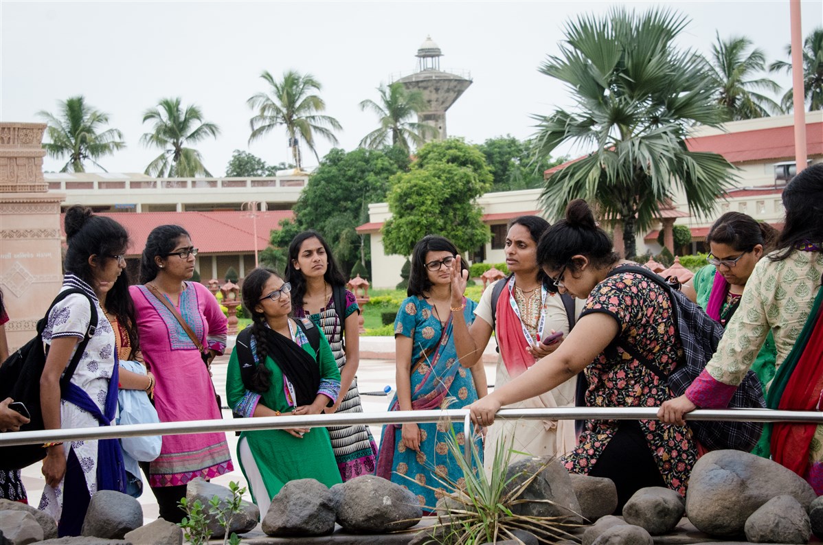 Delegates listen to the lead as she explains the importance of prasadi sthans in Junagadh