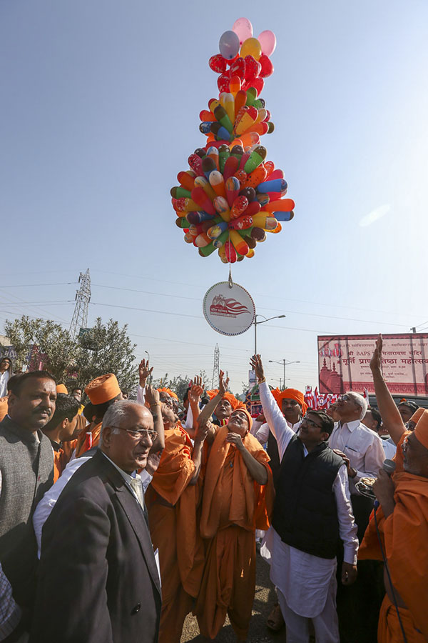 Pujya Ishwarcharan Swami releases balloons at the beginning of the nagar yatra