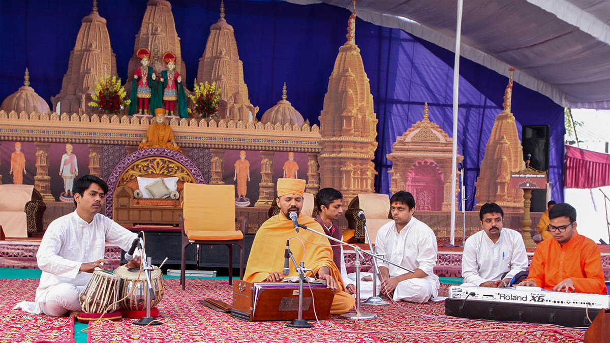 Sadhus and youths sing kirtans during the murti-pratishtha assembly