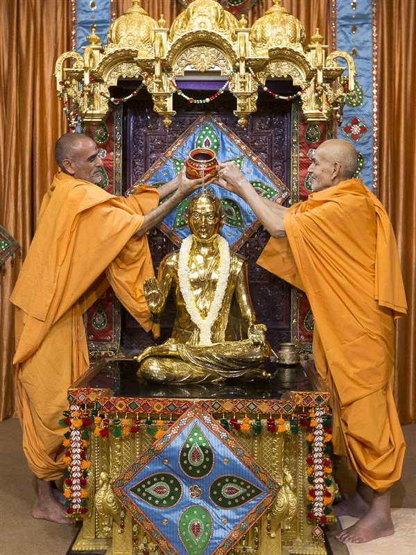 Swamishri and Anandswarup Swami perform abhishek of Shri Bhagwan Swaminarayan (abhishek murti), 16 Apr 2017