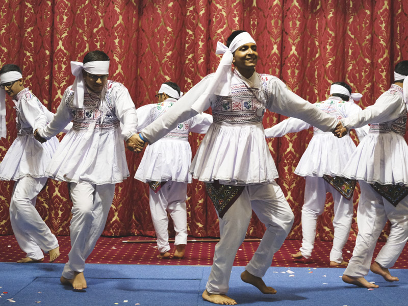 Youths perform a cultural dance in the welcome assembly