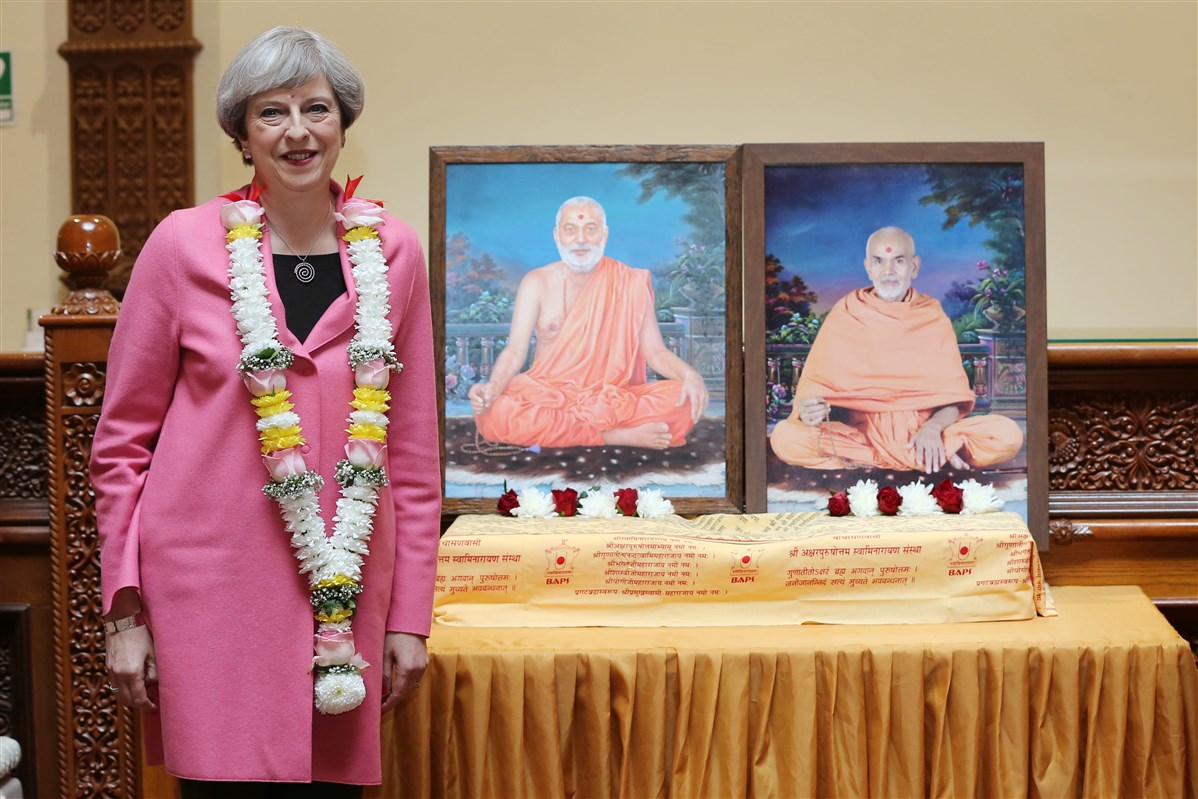 Prime Minister Theresa May is welcomed in the traditional Hindu manner