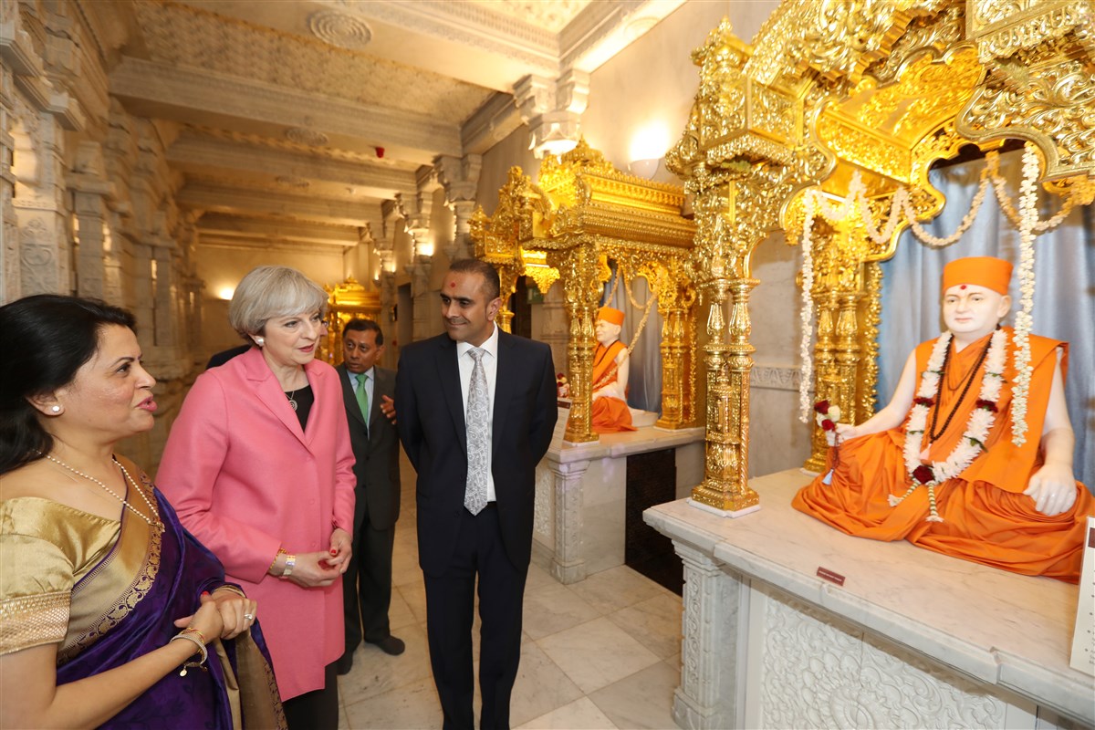 Prime Minister Theresa May learns about the creator of the Mandir, HH Pramukh Swami Maharaj