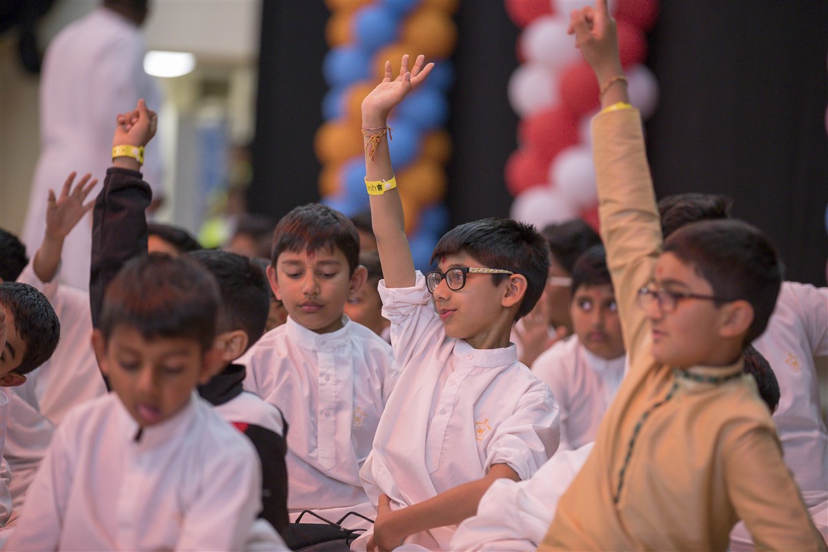 Children engage with Swamishri in a question-and-answer session