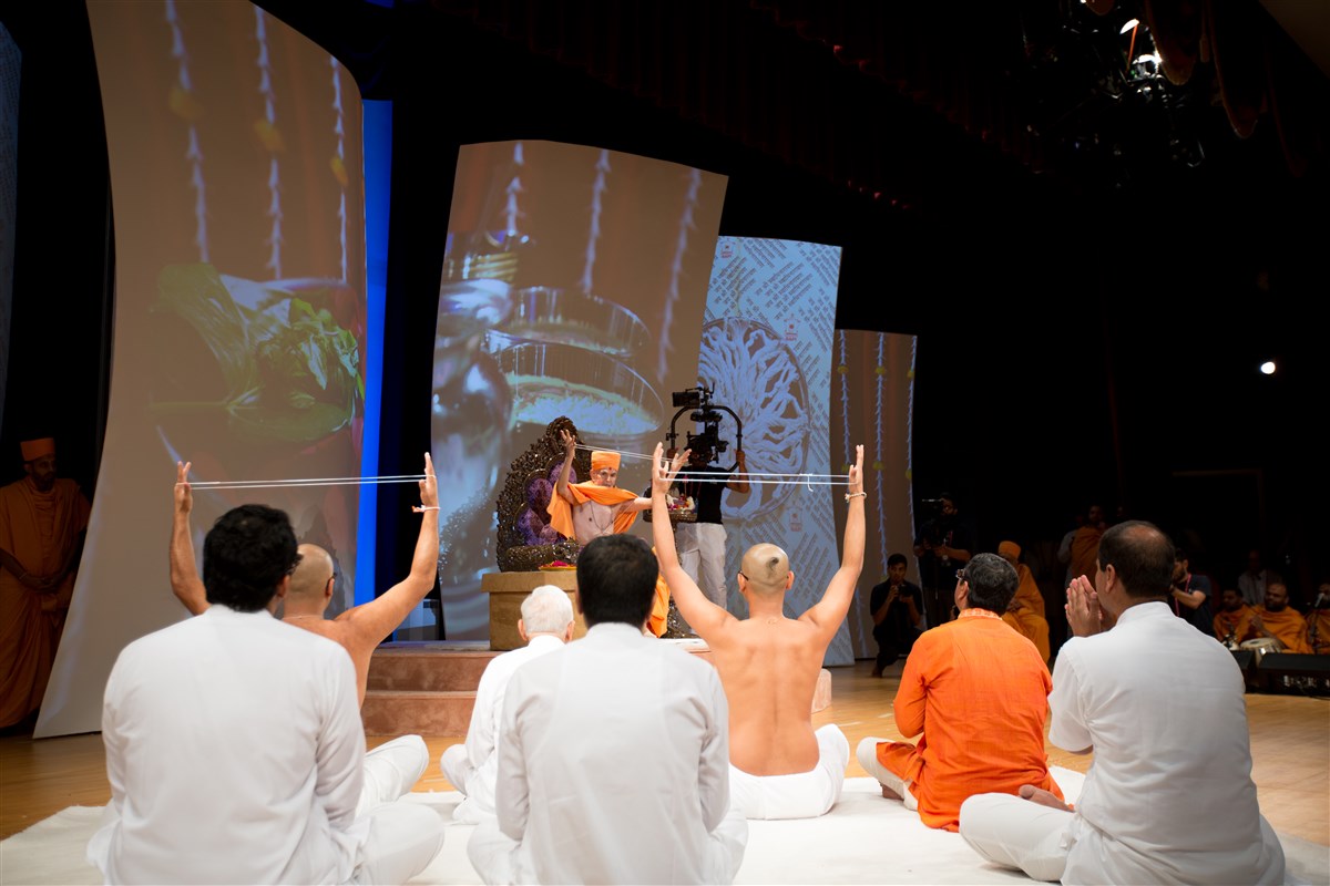 Swamishri and the two youths engaged in the diksha ceremony, 2 July 2017