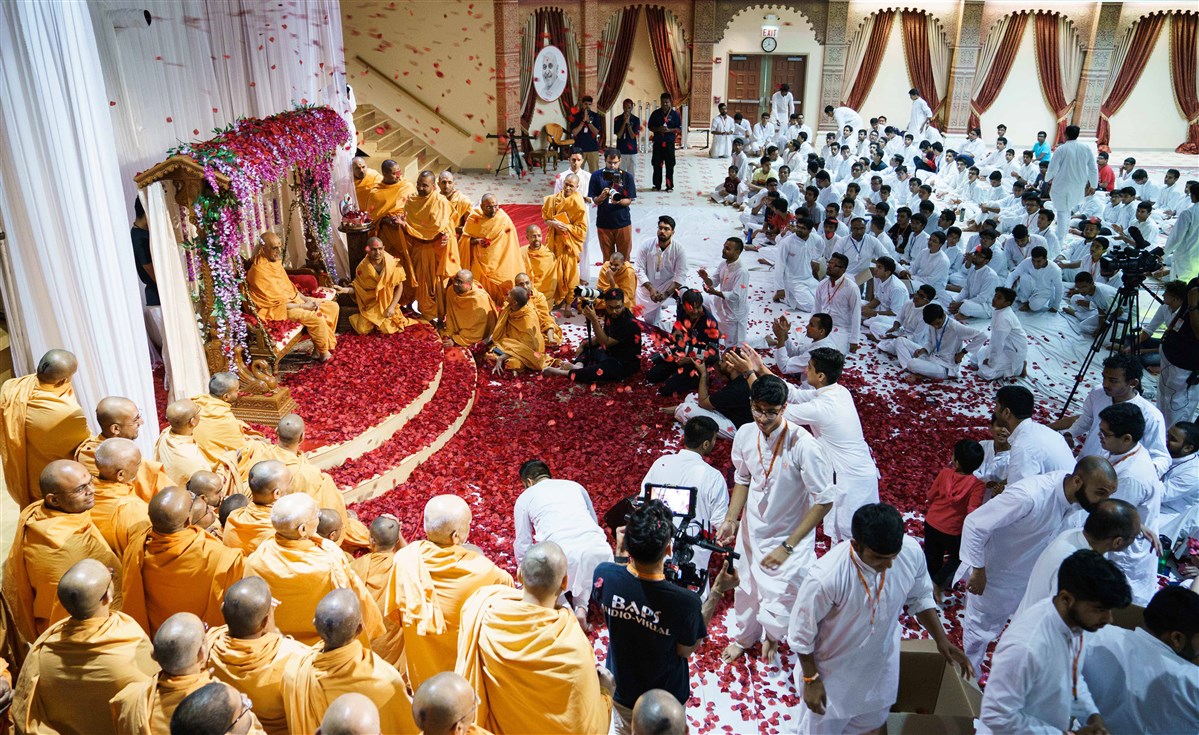 Swamishri is showered with flower petals