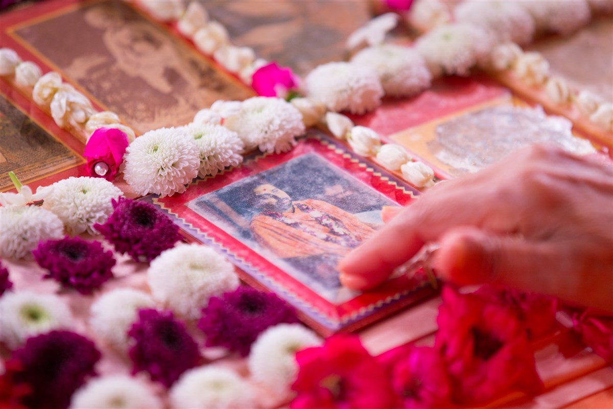 Swamishri touches the feet of the murti of Pramukh Swami Maharaj