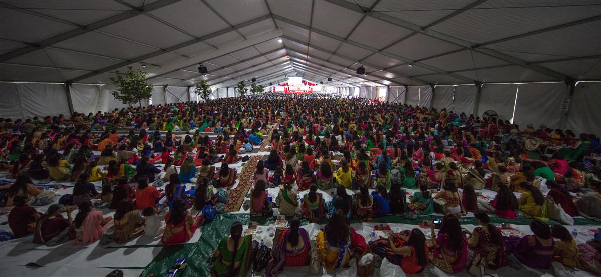 Devotees engrossed in the mahapuja rituals