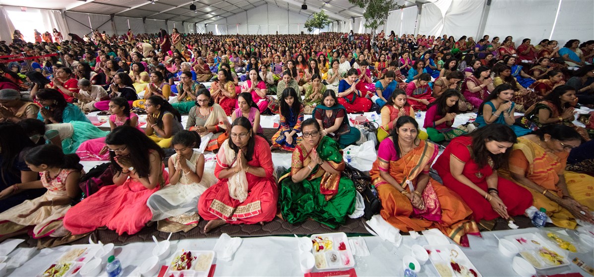 Devotees engrossed in the mahapuja rituals