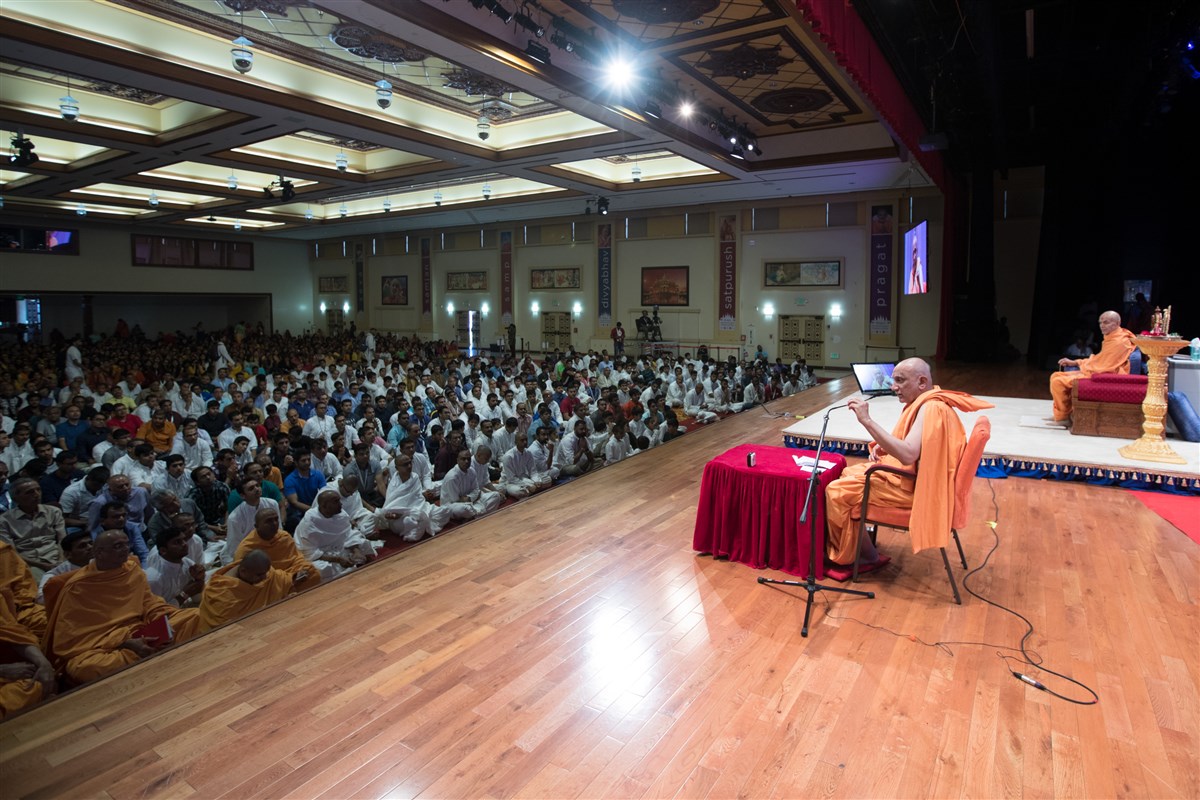 Swamishri listens to a discourse in the assembly