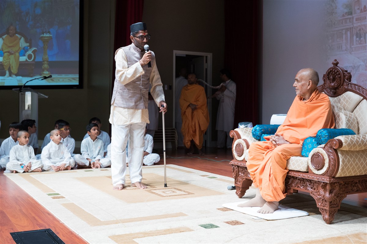 A youth performs a skit before Swamishri