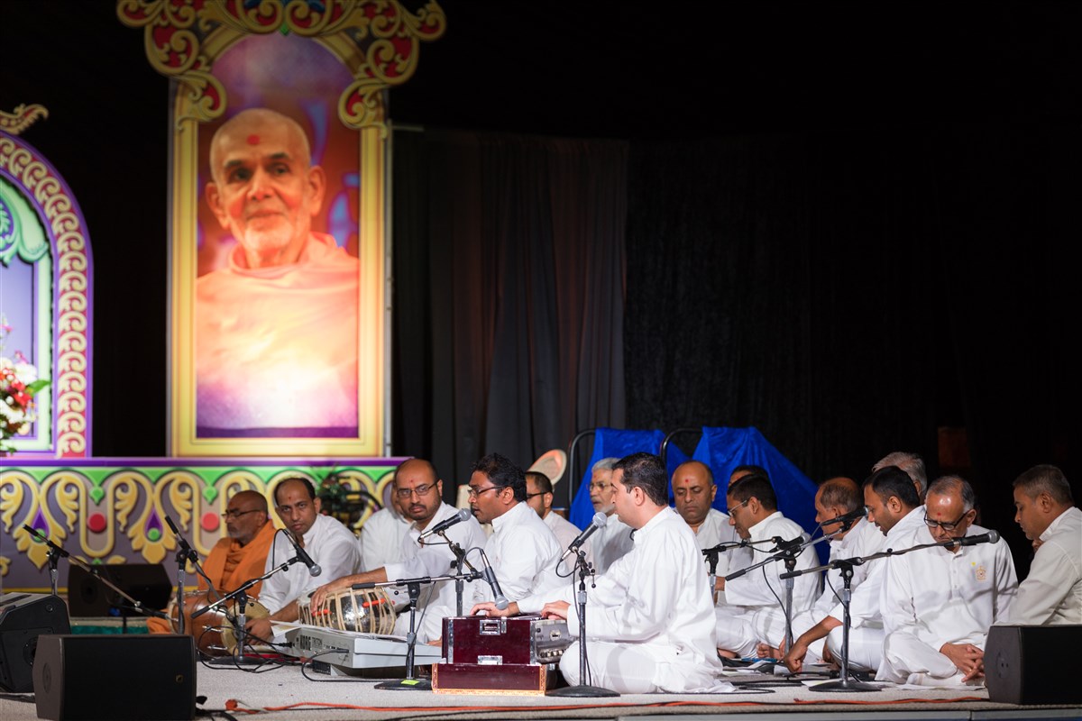 Devotees sing kirtans during Swamishri's puja