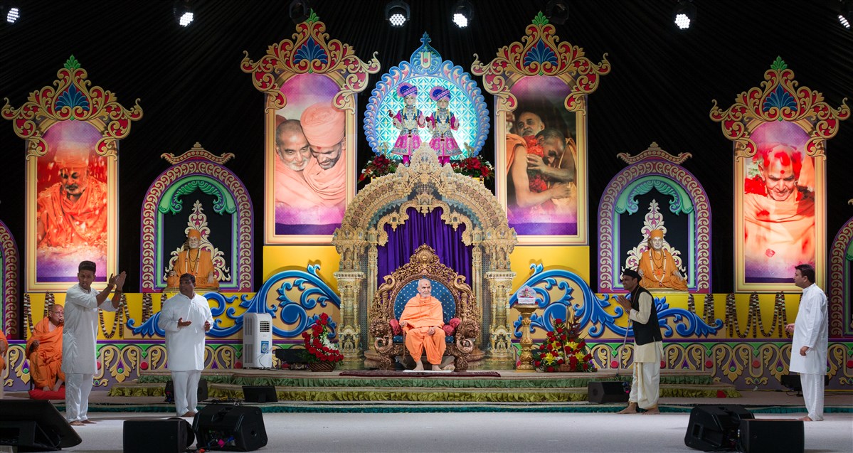 Devotees perform a skit before Swamishri 