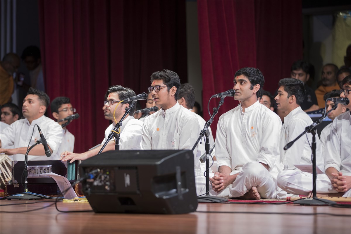 Youths sing kirtans during puja