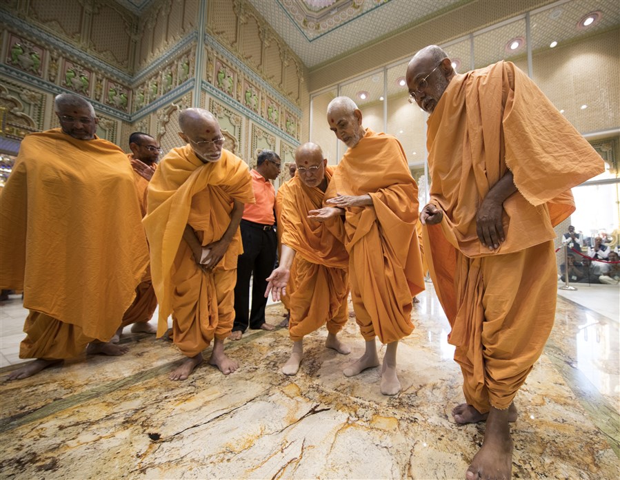 Swamishri observes the flooring of the Pramukh Swami Mandapam