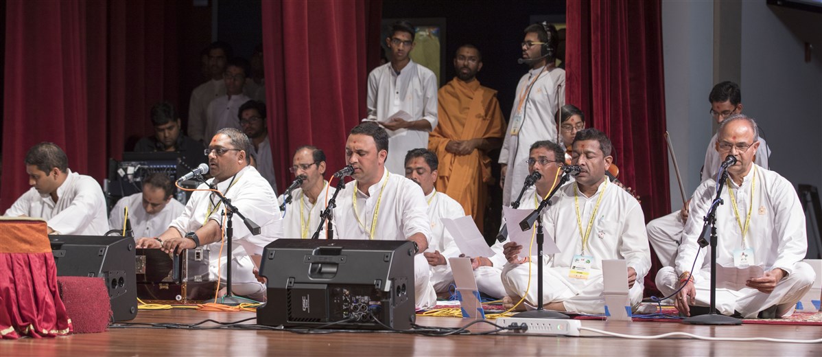 Devotees sing kirtans during puja