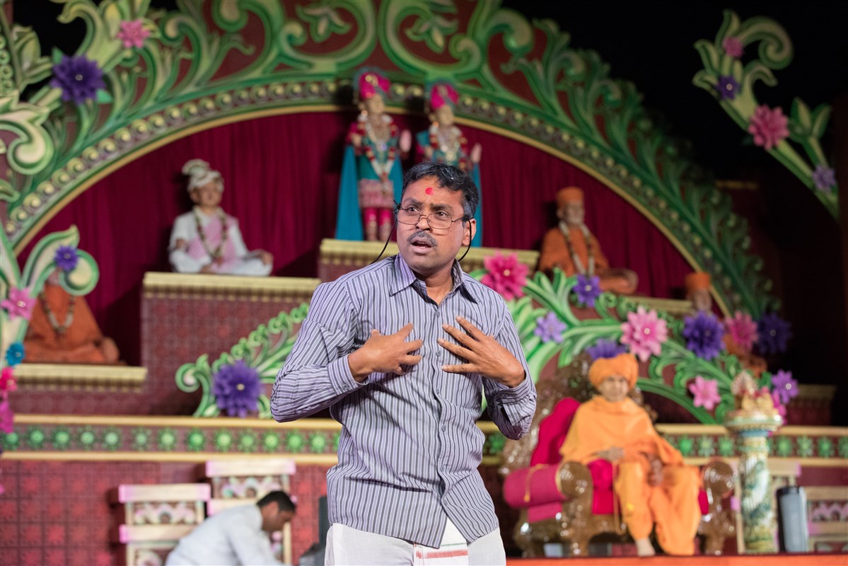 A devotee performs a skit before Swamishri
