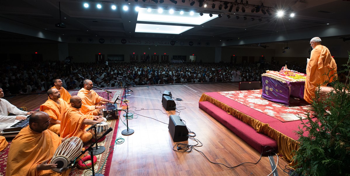 Swamis sing kirtans before Swamishri during puja 