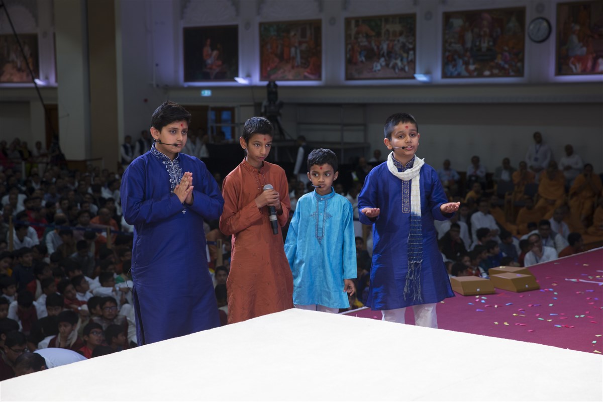 Children perform various presentations in Swamishri's puja