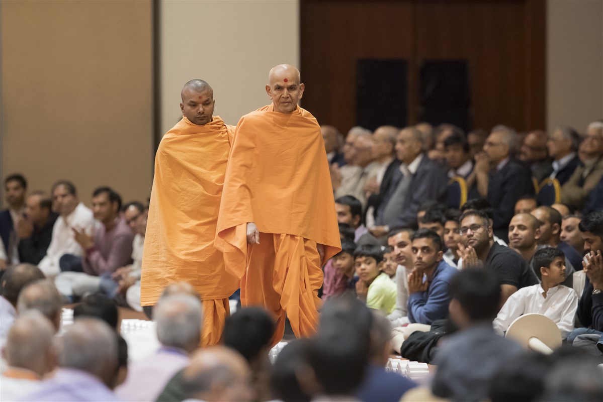 Swamishri performs his afternoon walk in the assembly hall